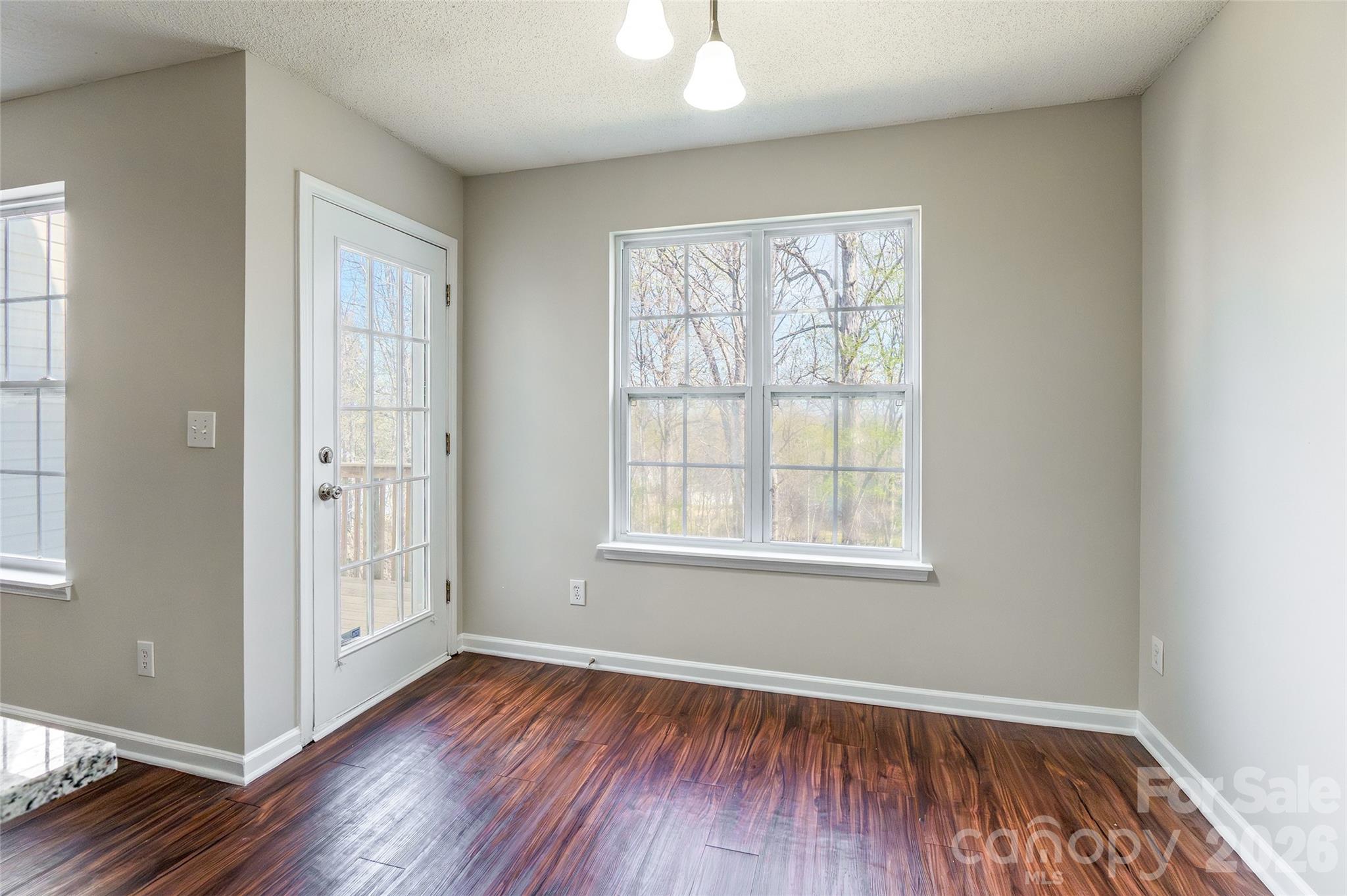 3167 Caldwell Ridge Parkway Charlotte, NC 28213 - Photo 13 of 36 an empty room with wooden floor and windows