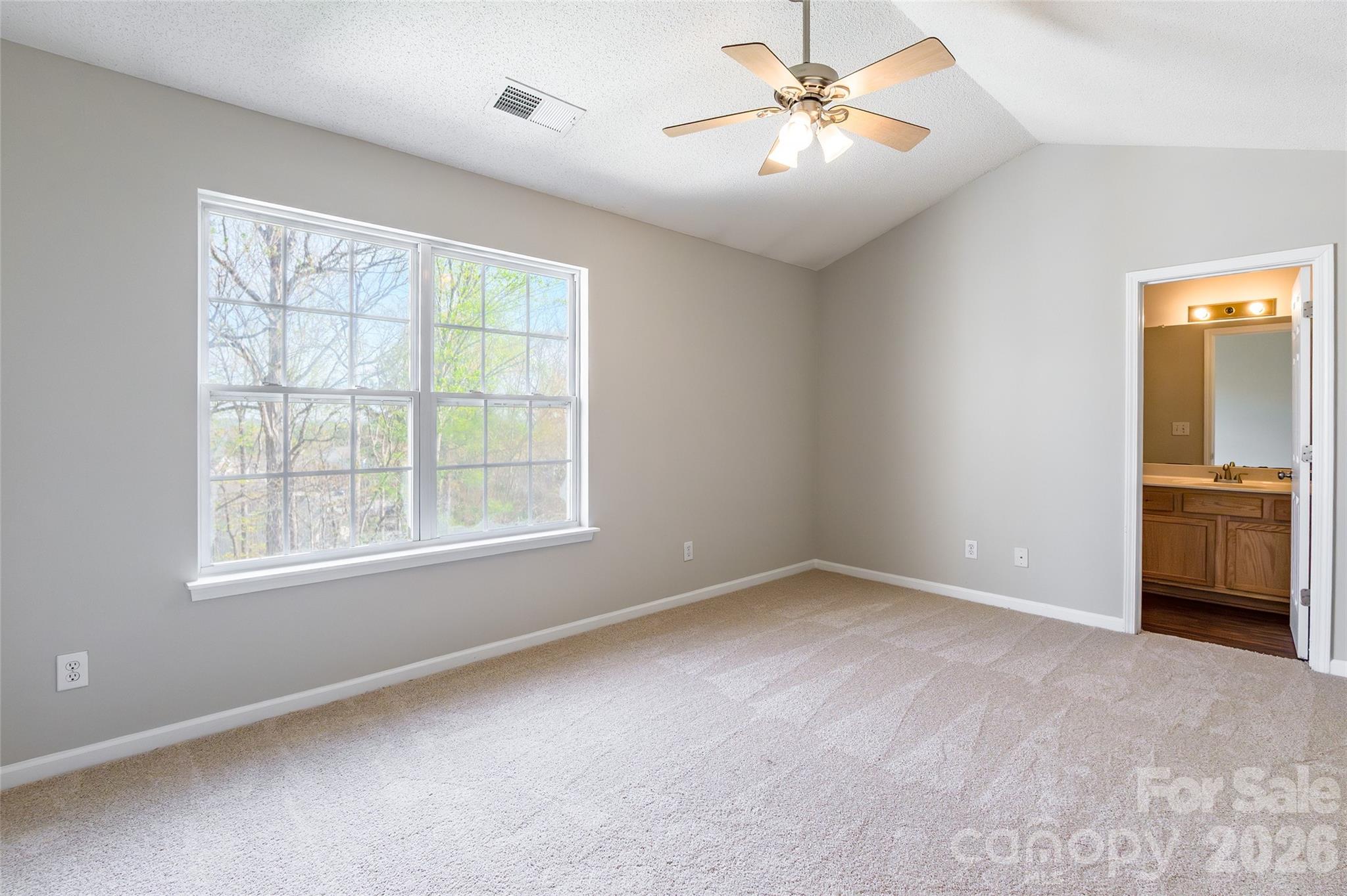 3167 Caldwell Ridge Parkway Charlotte, NC 28213 - Photo 19 of 36 an empty room with chandelier fan and windows