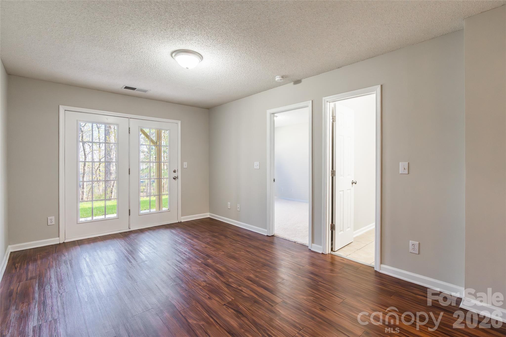 3167 Caldwell Ridge Parkway Charlotte, NC 28213 - Photo 26 of 36 an empty room with wooden floor and windows