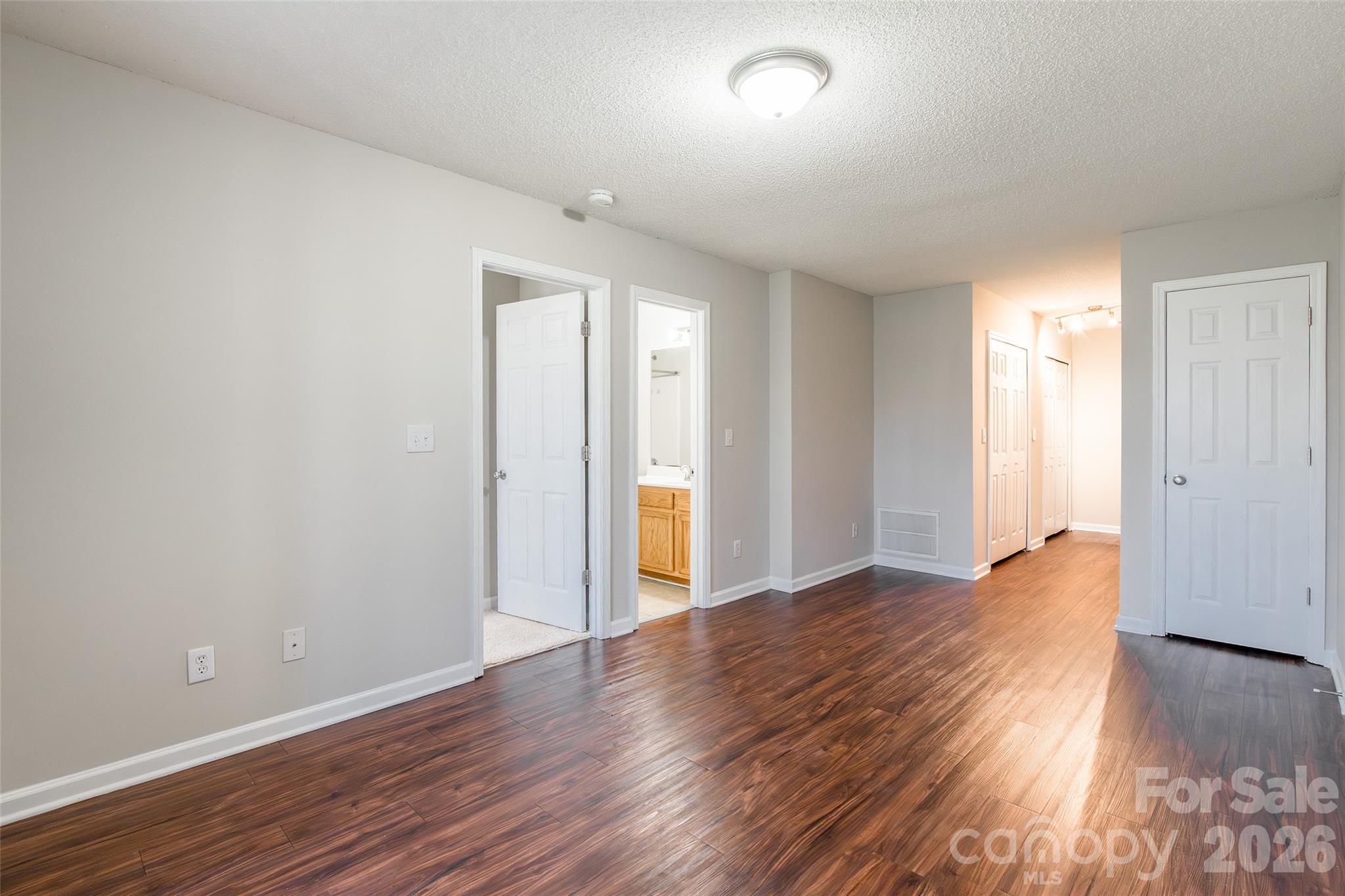 3167 Caldwell Ridge Parkway Charlotte, NC 28213 - Photo 27 of 36 an empty room with wooden floor and natural light