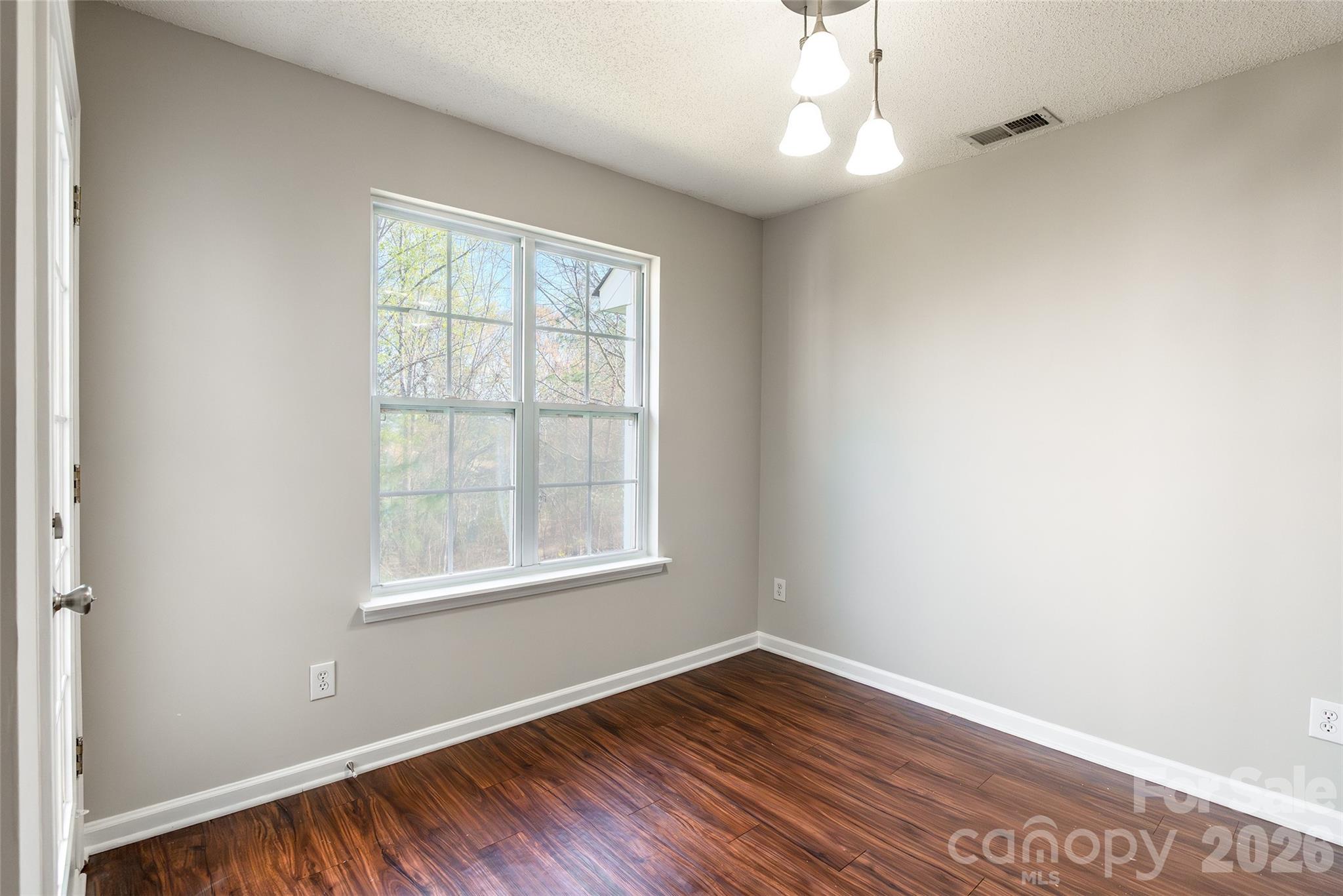 3167 Caldwell Ridge Parkway Charlotte, NC 28213 - Photo 36 of 36 an empty room with wooden floor windows and fan