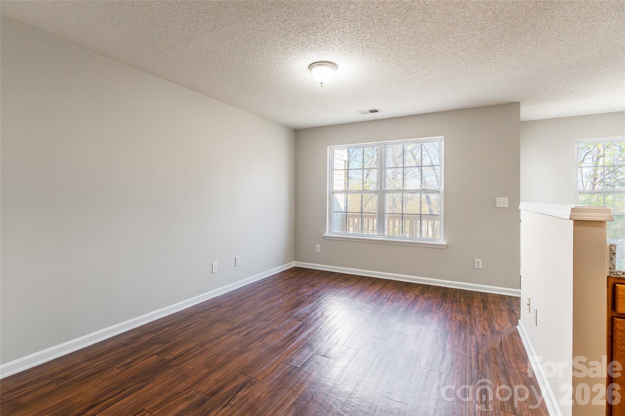 3167 Caldwell Ridge Parkway Charlotte, NC 28213 - Photo 6 of 36 an empty room with wooden floor and windows
