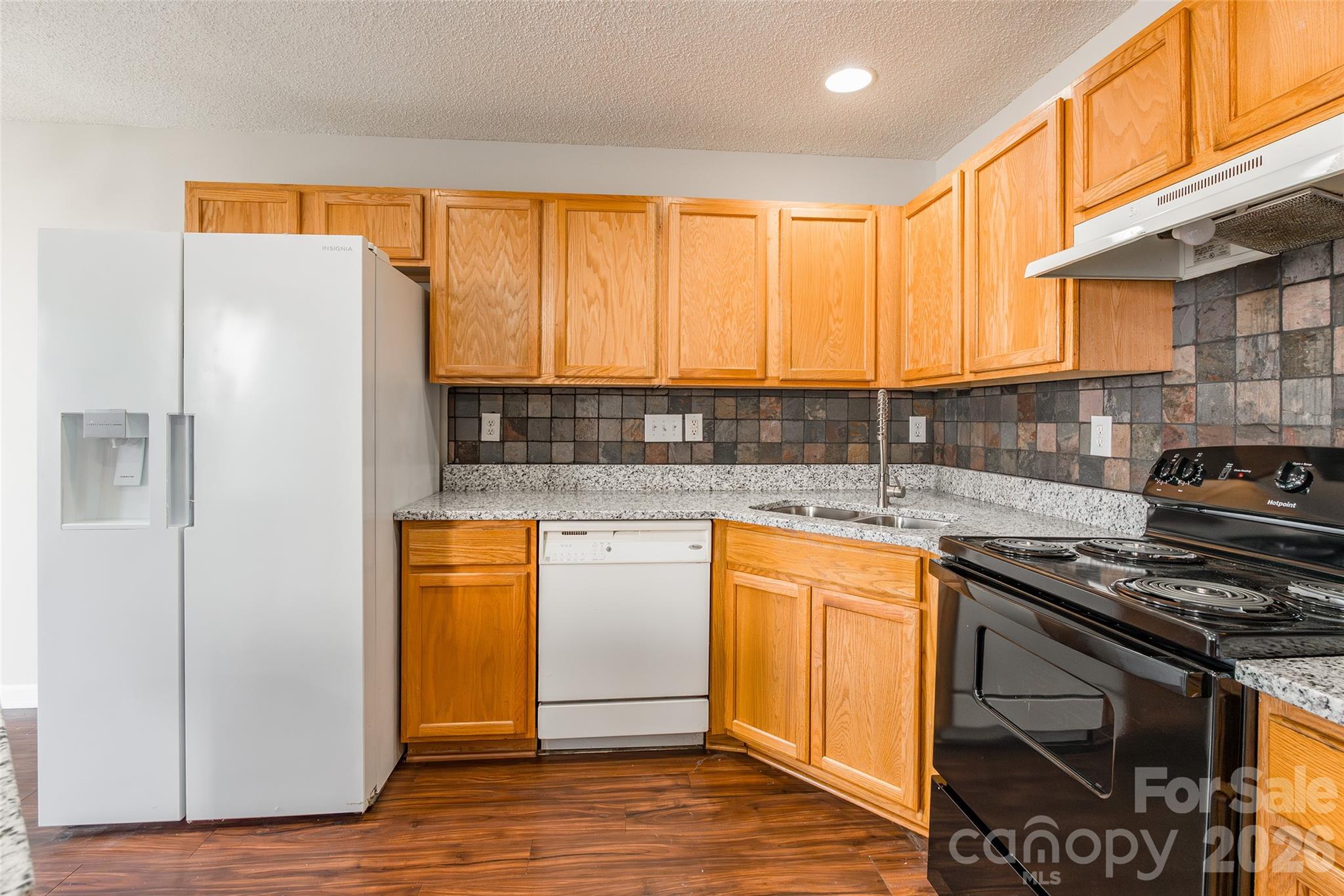 3167 Caldwell Ridge Parkway Charlotte, NC 28213 - Photo 10 of 36 a kitchen with stainless steel appliances granite countertop a stove a sink and a refrigerator