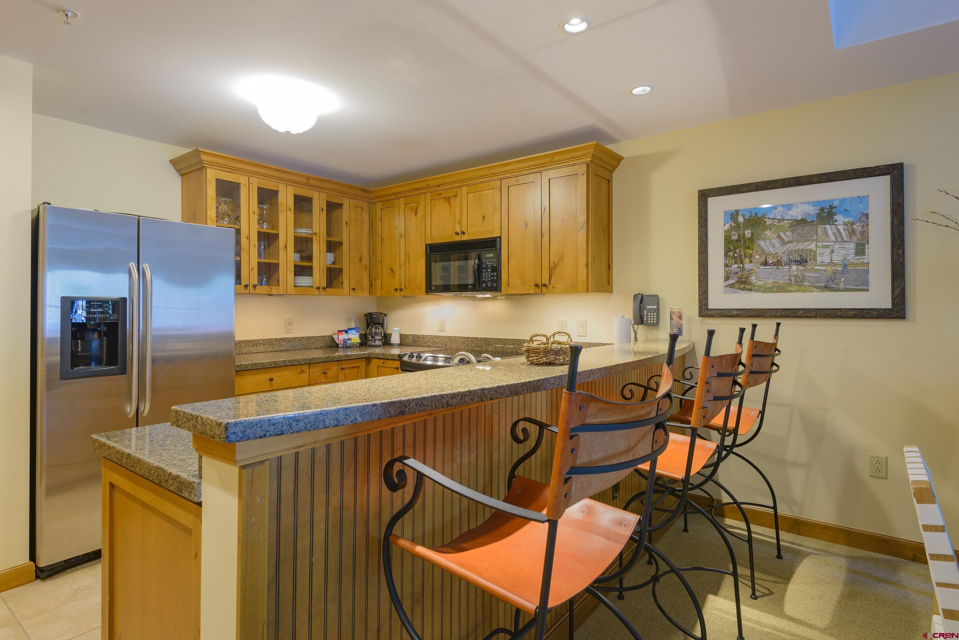 620 Gothic Road, Unit 317 Crested Butte, CO 81225 - Photo 18 of 43 a kitchen that has a table and chairs in it