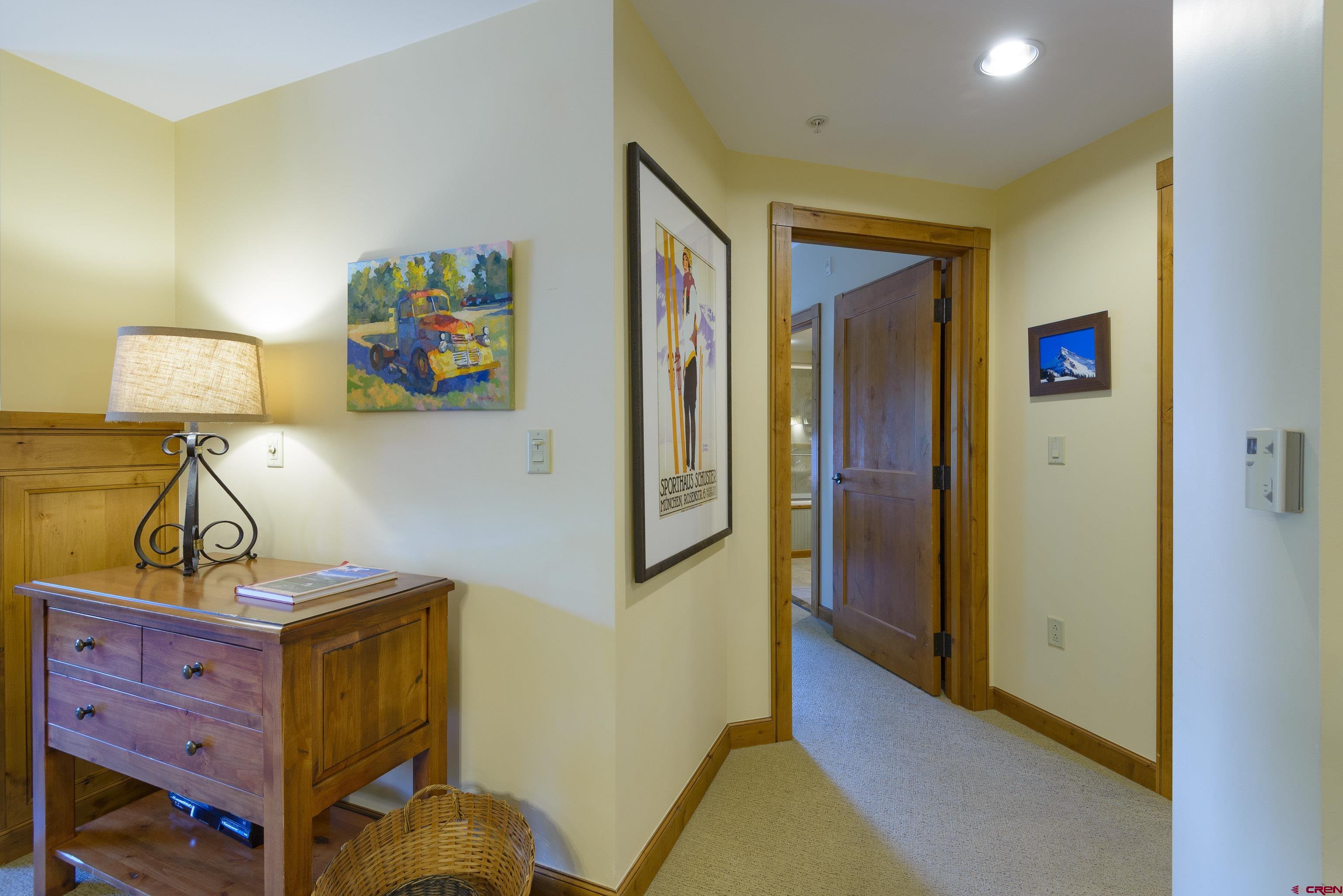 620 Gothic Road, Unit 317 Crested Butte, CO 81225 - Photo 25 of 43 a bedroom with a bed and wooden floor