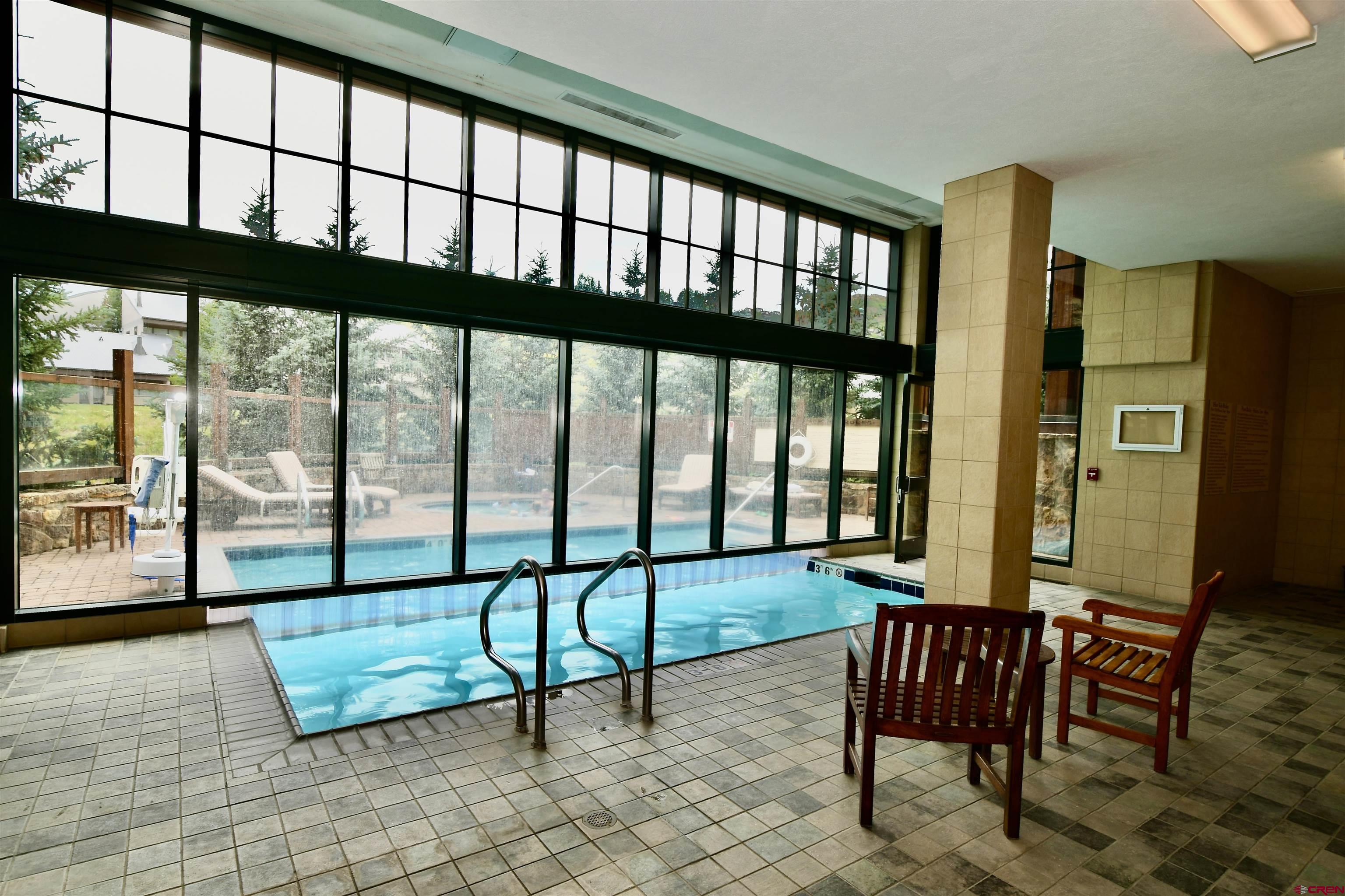 620 Gothic Road, Unit 317 Crested Butte, CO 81225 - Photo 38 of 43 a view of a living room with furniture and floor to ceiling window