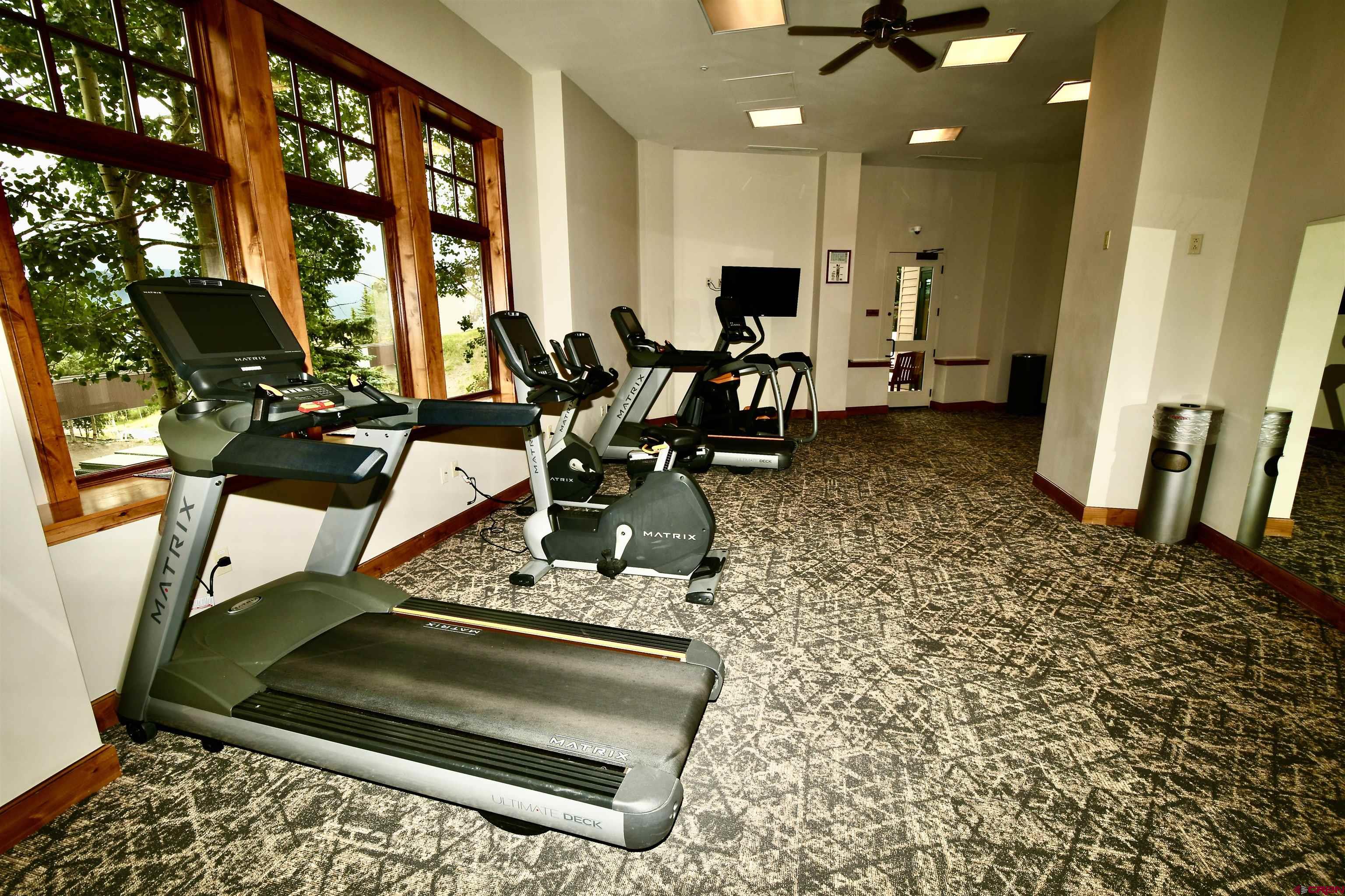 620 Gothic Road, Unit 317 Crested Butte, CO 81225 - Photo 39 of 43 a living room with furniture a flat screen tv and a large window
