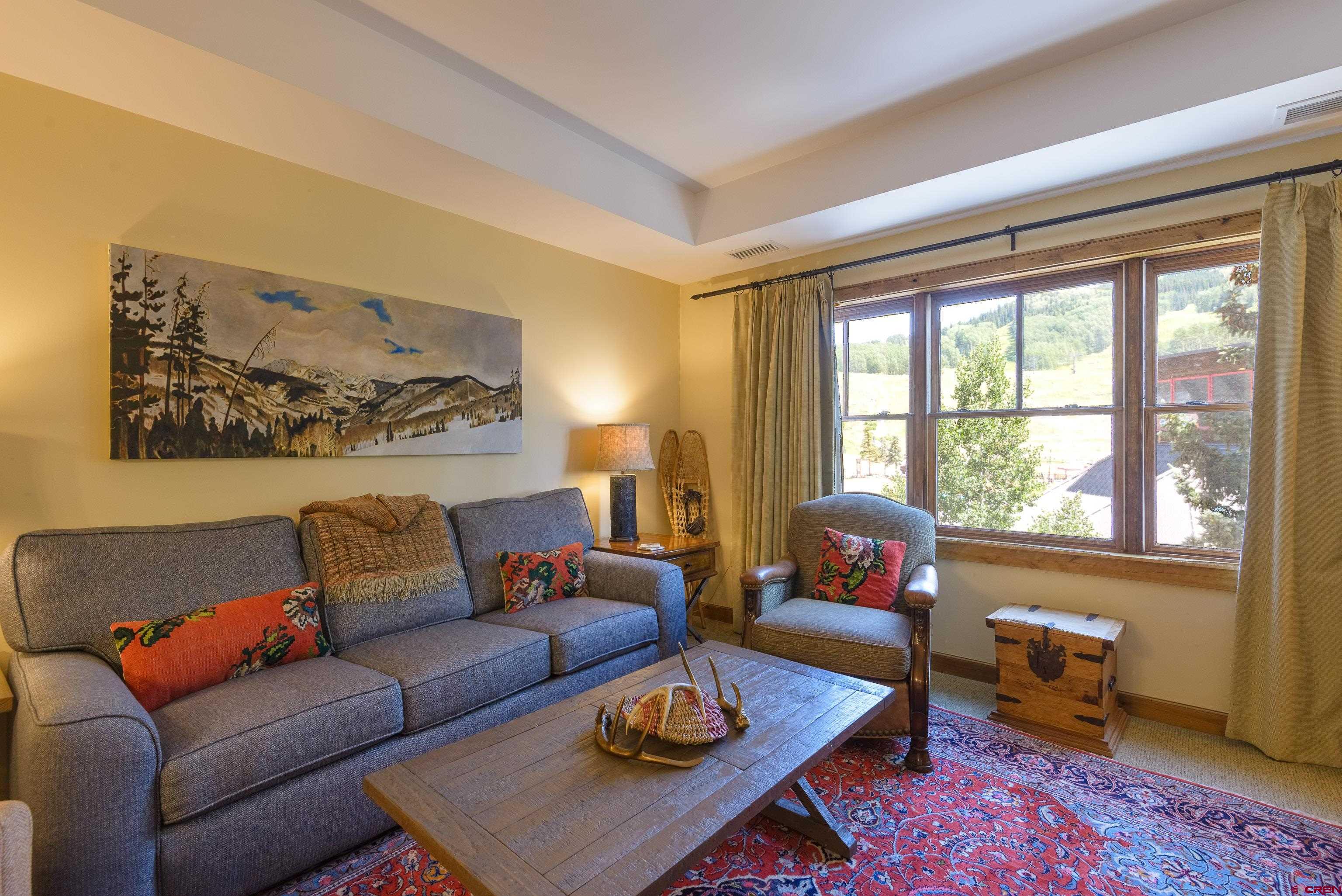 620 Gothic Road, Unit 317 Crested Butte, CO 81225 - Photo 4 of 43 a living room with furniture and a large window