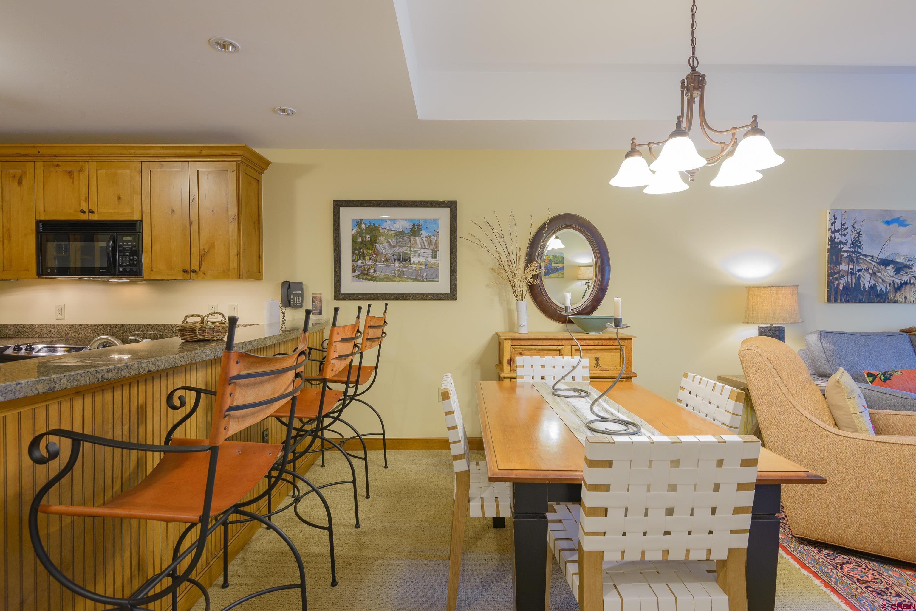 620 Gothic Road, Unit 317 Crested Butte, CO 81225 - Photo 6 of 43 a view of a dining room with furniture and a chandelier