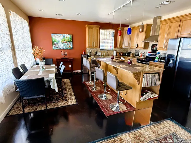 a very nice looking dining room with a large window