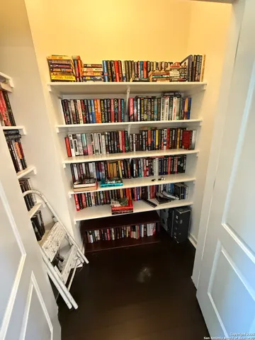 a view of a workspace with furniture and a book shelf
