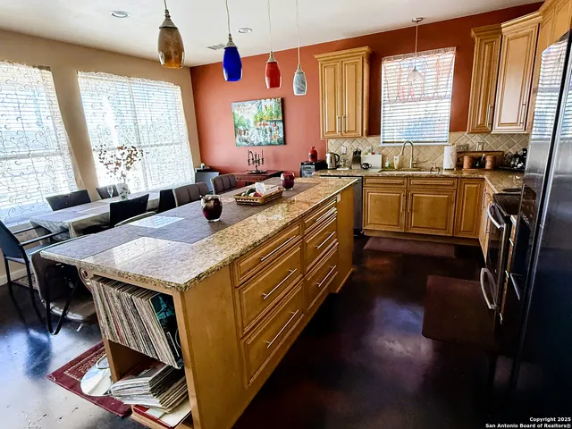a kitchen with a stove a sink and a refrigerator