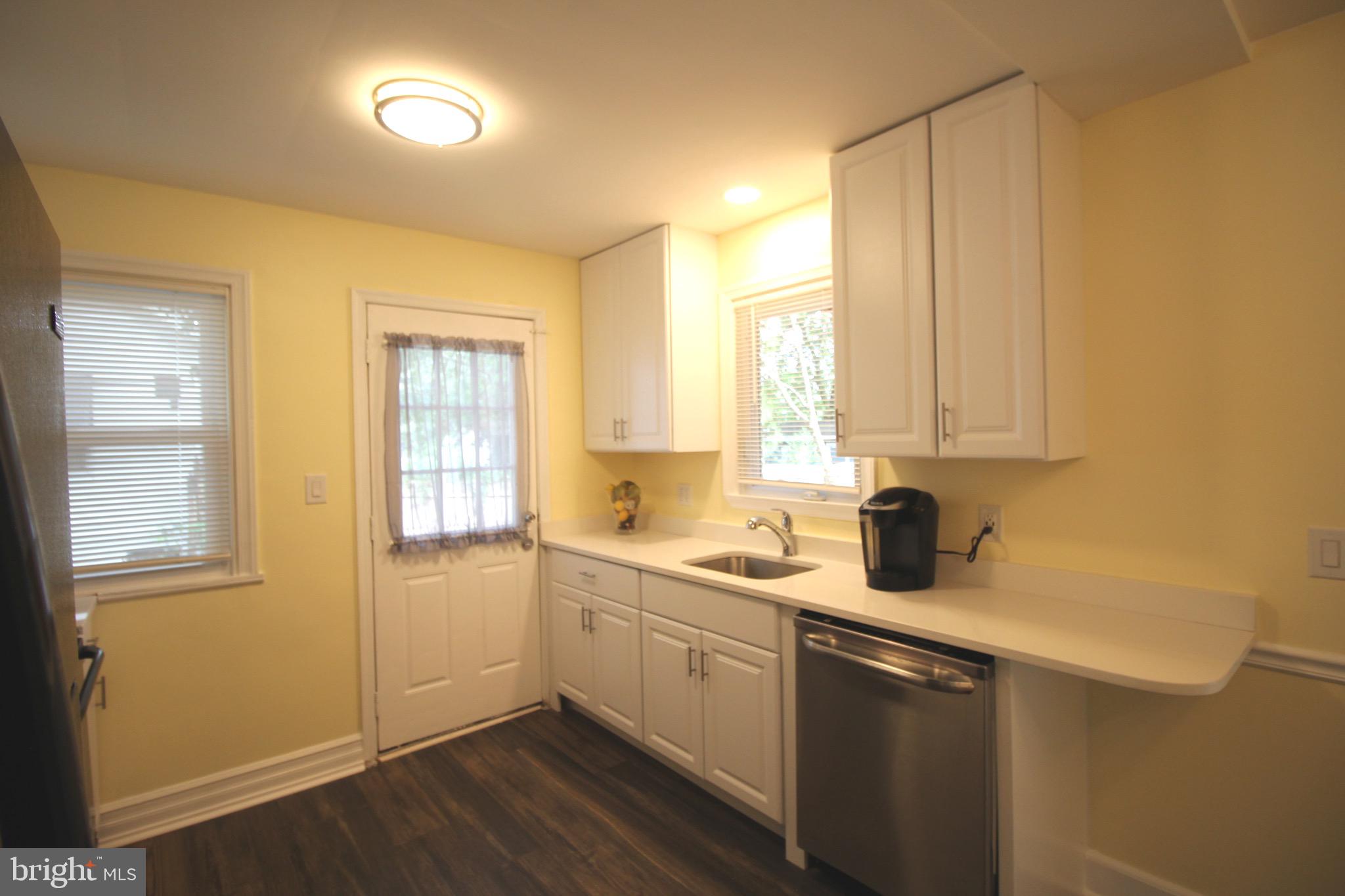 209 Champlain Avenue Wilmington, DE 19804 - Photo 7 of 26 a kitchen with a sink a window and cabinets
