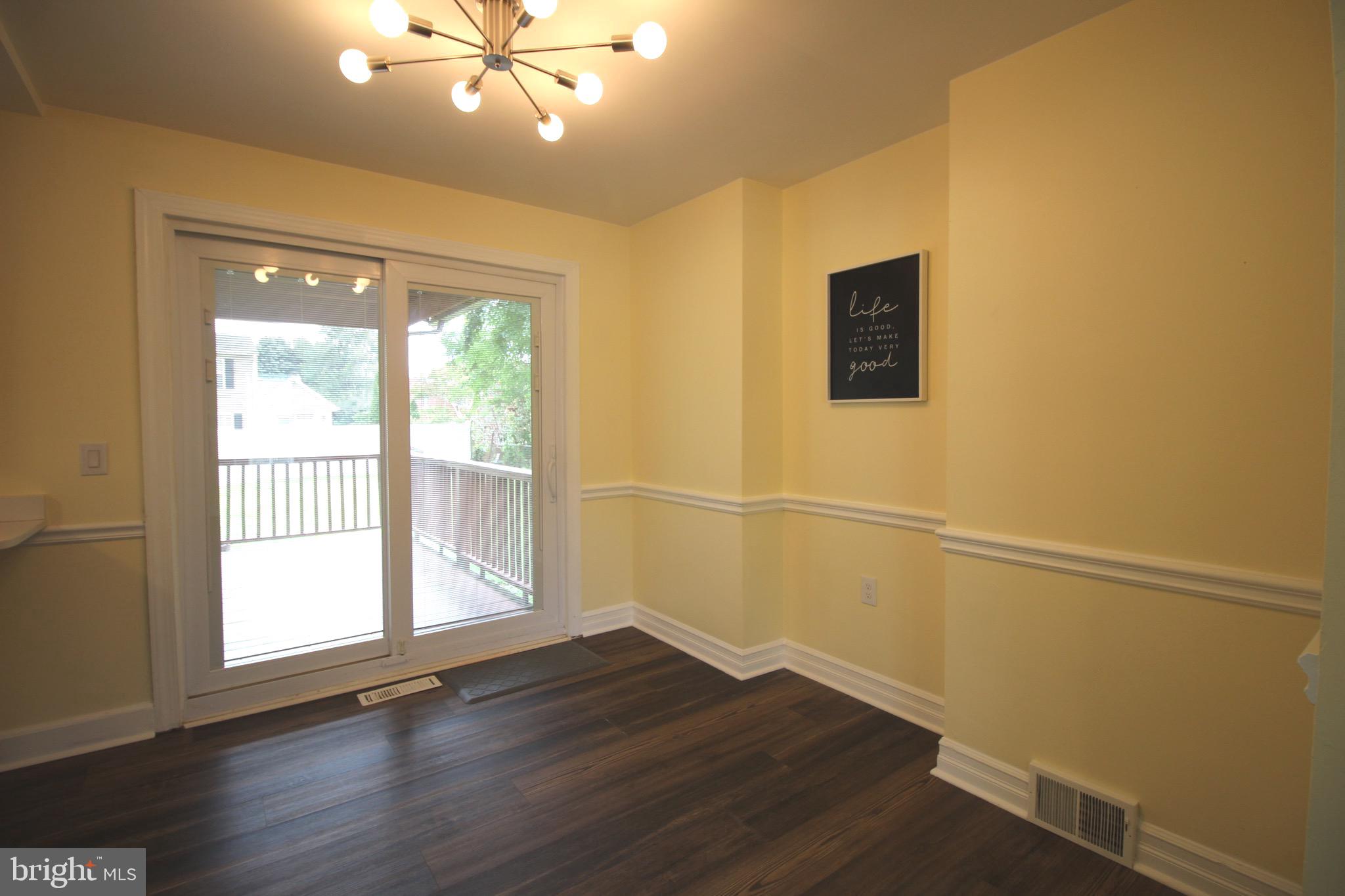 209 Champlain Avenue Wilmington, DE 19804 - Photo 8 of 26 a view of an empty room with wooden floor and a window