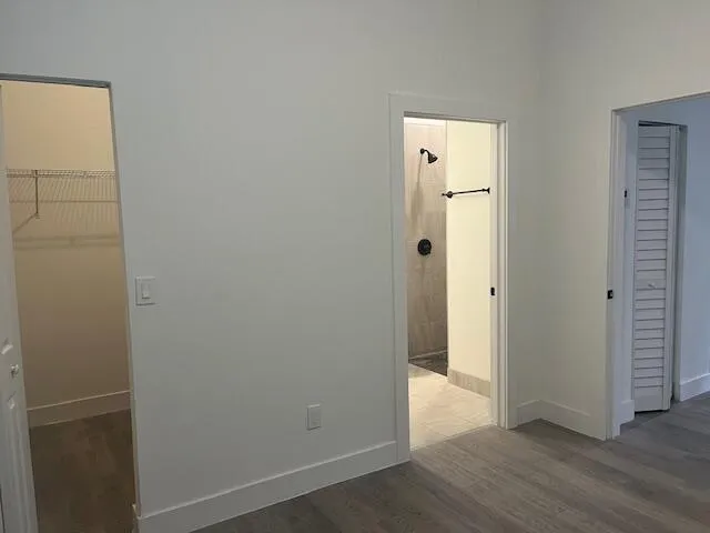 an empty room with wooden floor and closet