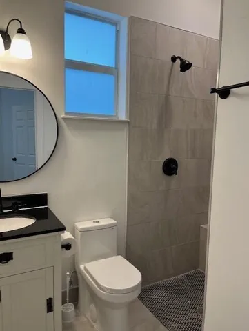 a bathroom with a toilet a sink and shower