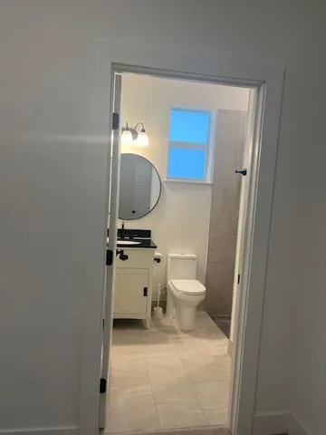 a white toilet sitting next to a bathroom sink