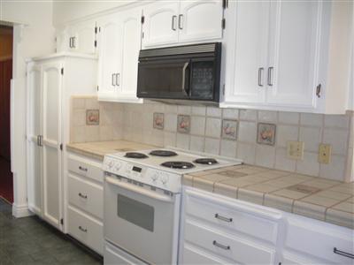 1425 West Flora Avenue Reedley, CA 93654 - Photo 29 of 48 Kitchen, beautiful tile counter tops and white cabinets.