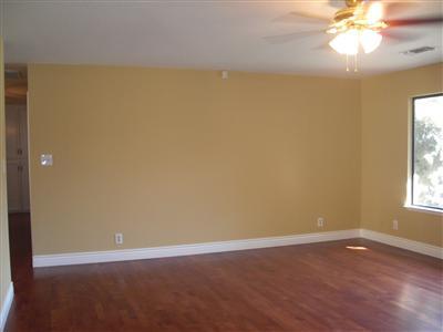 1425 West Flora Avenue Reedley, CA 93654 - Photo 8 of 48 Living Room, wood floor covering, ceiling fan, fresh paint.