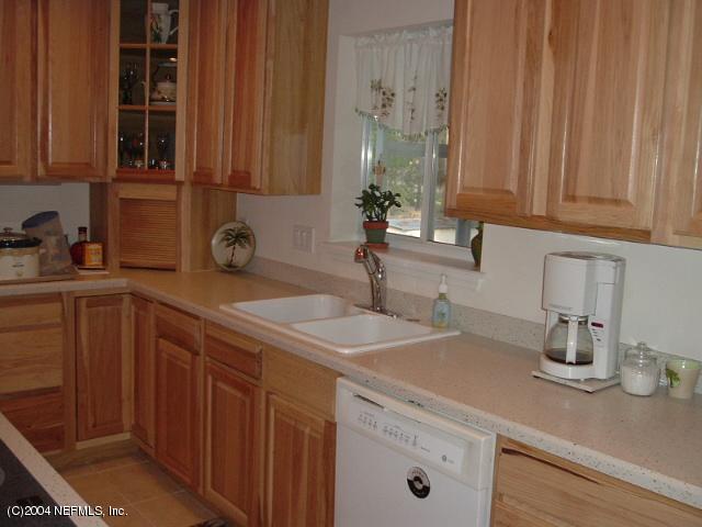 8435 Florence Cove Road St. Augustine, FL 32092 - Photo 12 of 20 a kitchen with a sink and cabinets