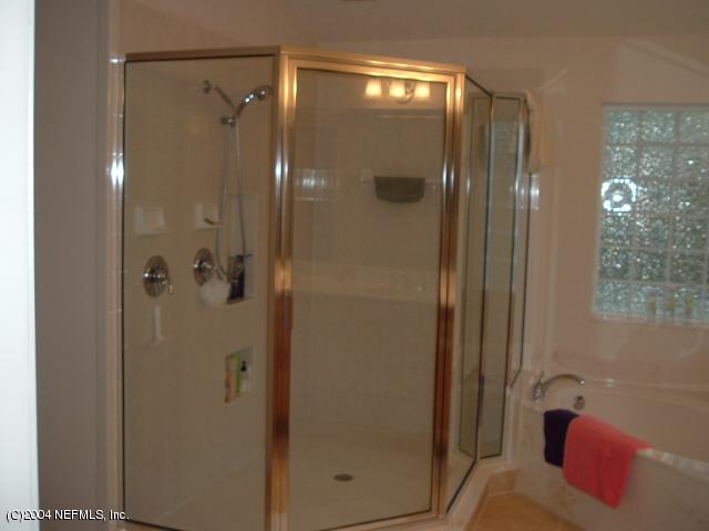8435 Florence Cove Road St. Augustine, FL 32092 - Photo 17 of 20 a bathroom with a glass shower door