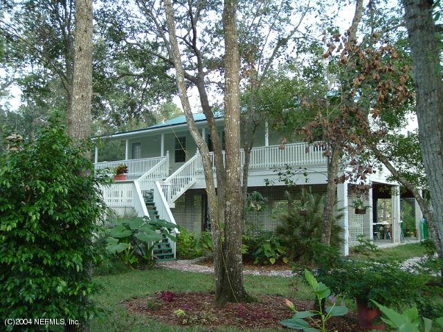 8435 Florence Cove Road St. Augustine, FL 32092 - Photo 2 of 20 a view of a house with a yard and potted plants