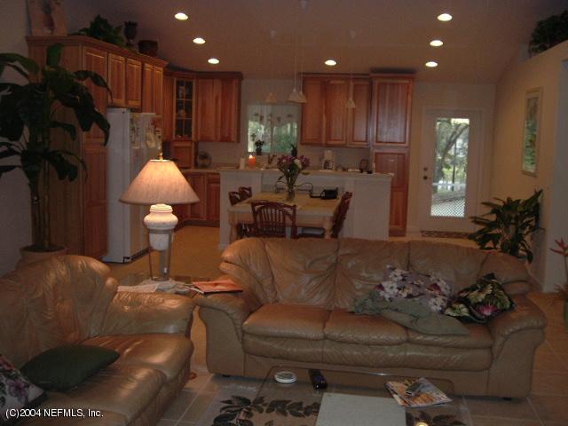 8435 Florence Cove Road St. Augustine, FL 32092 - Photo 8 of 20 a living room with furniture and a chandelier