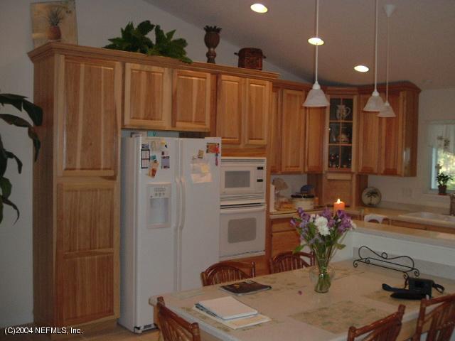 8435 Florence Cove Road St. Augustine, FL 32092 - Photo 9 of 20 a kitchen with refrigerator a sink and a stove