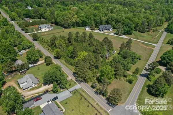 an aerial view of a residential houses with outdoor space