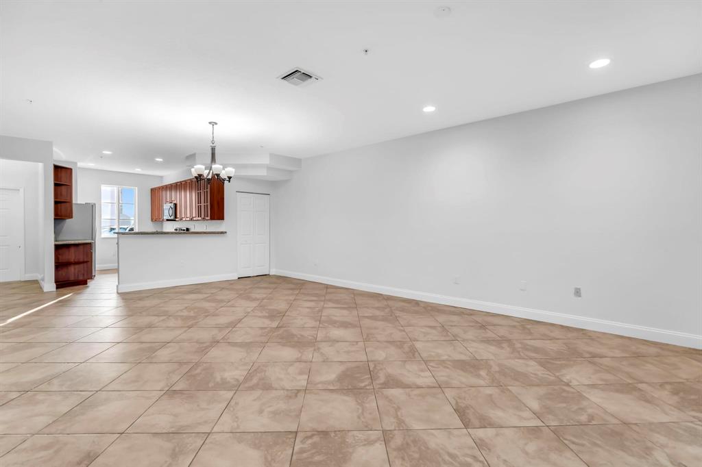 5030 Southwest 126th Avenue, Unit 203 Miramar, FL 33027 - Photo 12 of 41 a view of a kitchen with a sink and a refrigerator