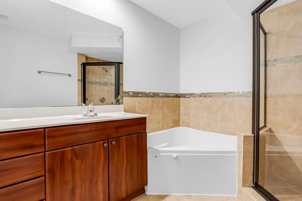 5030 Southwest 126th Avenue, Unit 203 Miramar, FL 33027 - Photo 15 of 41 a bathroom with a sink a mirror and a shower