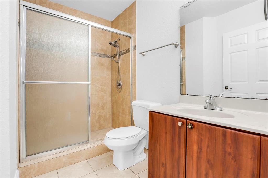 5030 Southwest 126th Avenue, Unit 203 Miramar, FL 33027 - Photo 19 of 41 a bathroom with a granite countertop sink toilet and shower