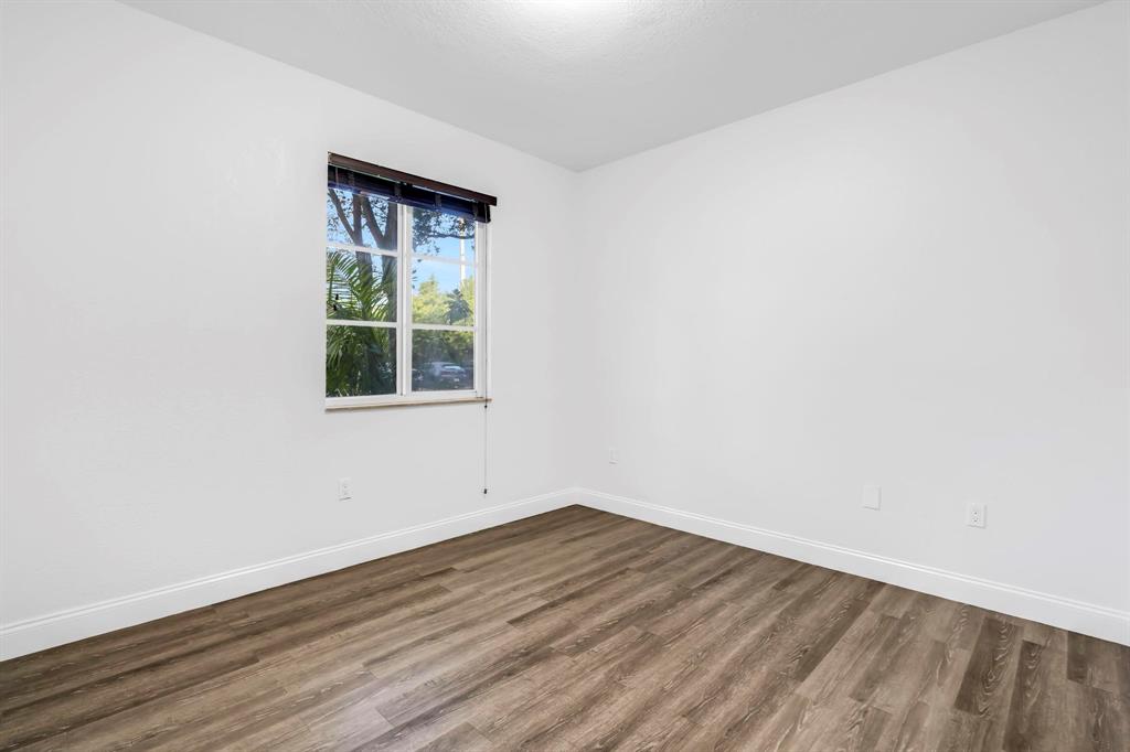 5030 Southwest 126th Avenue, Unit 203 Miramar, FL 33027 - Photo 21 of 41 an empty room with wooden floor and windows