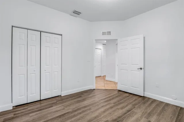 a view of an empty room and wooden floor