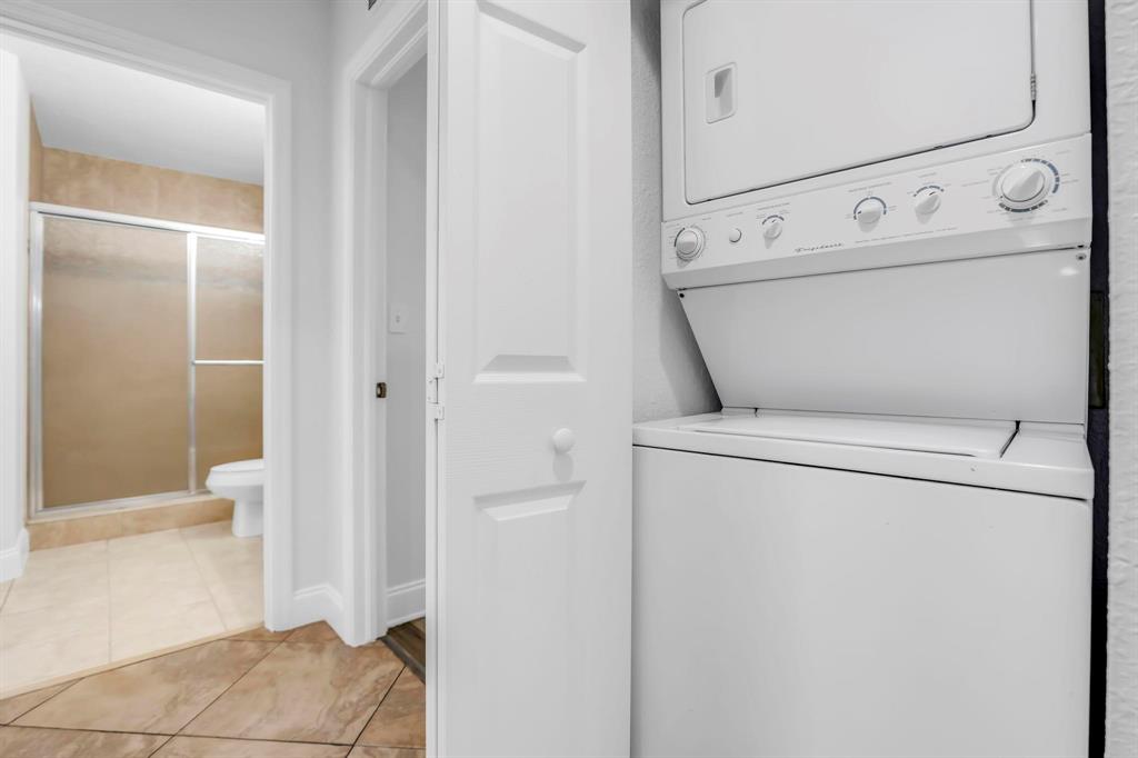5030 Southwest 126th Avenue, Unit 203 Miramar, FL 33027 - Photo 25 of 41 a view of washer and dryer with bathroom in the background