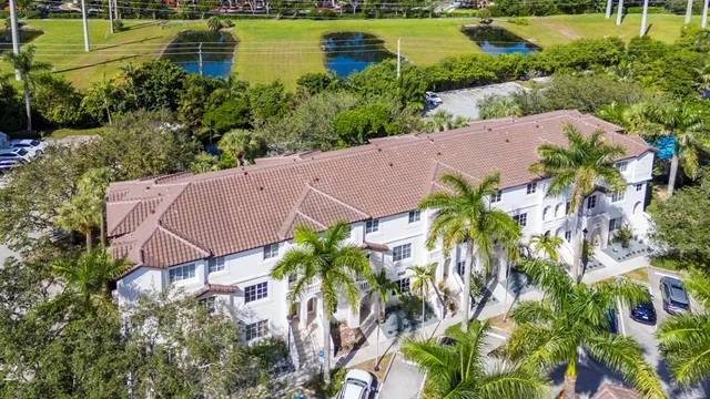 an aerial view of a house with outdoor space and lake view in back