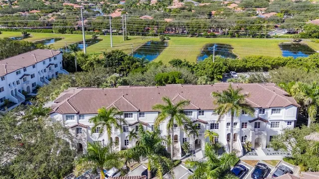an aerial view of residential houses with outdoor space and swimming pool