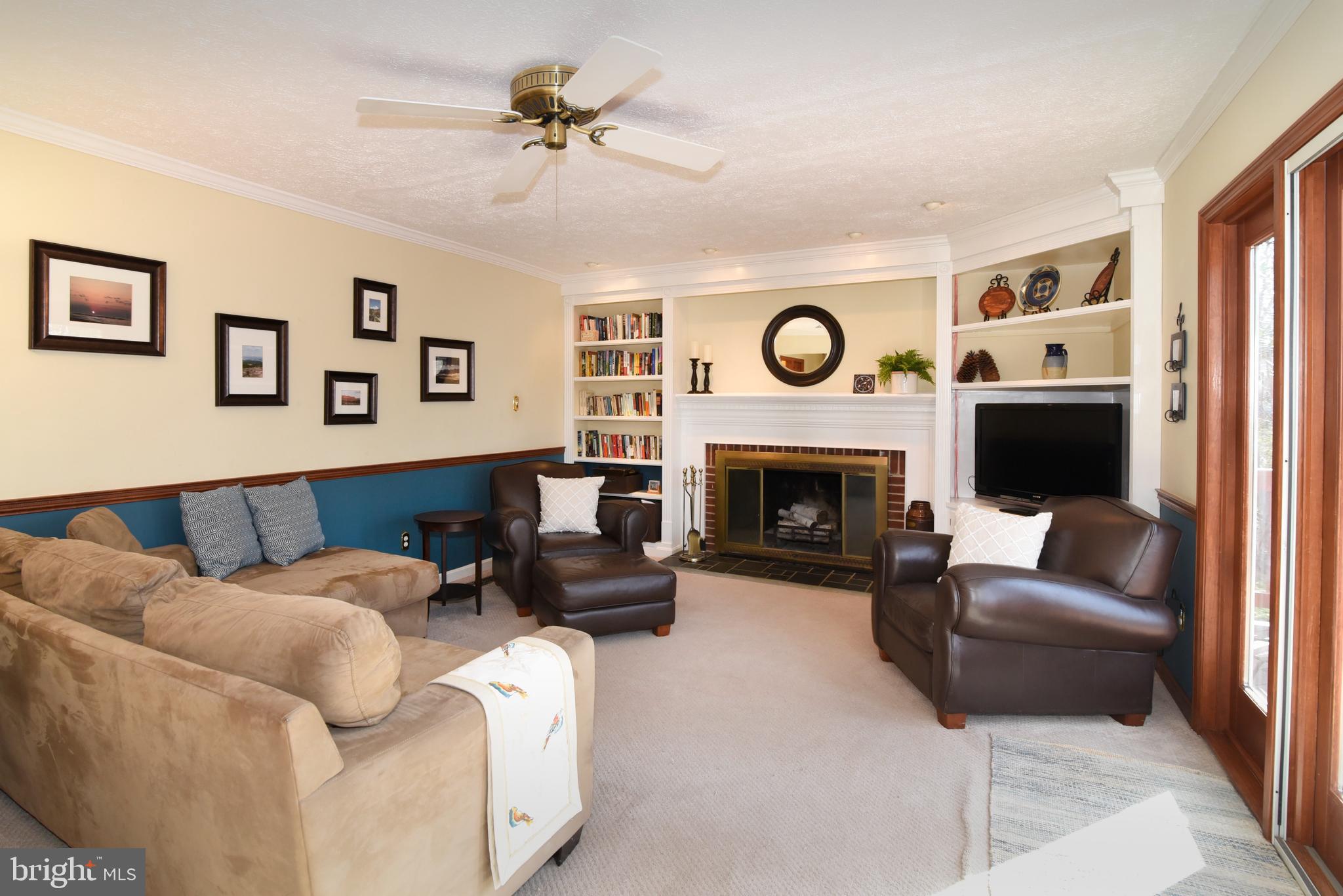 2208 Spinnaker Court Reston, VA 20191 - Photo 17 of 39 a living room with furniture a clock and a fireplace