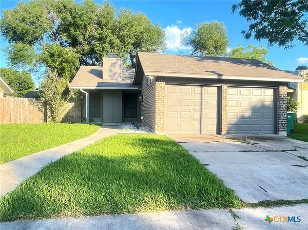 a view of a house with a garden and yard