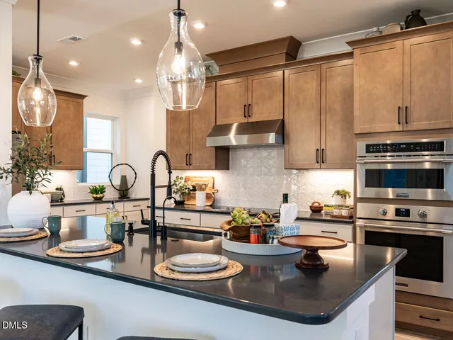 a kitchen with sink a stove and cabinets