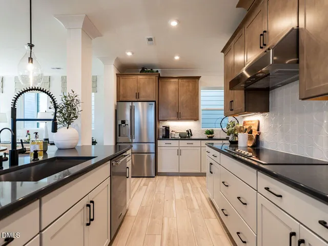 a kitchen with stainless steel appliances granite countertop sink stove top oven and refrigerator