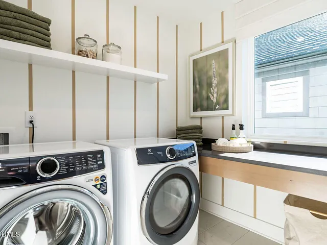 a utility room with sink dryer and washer