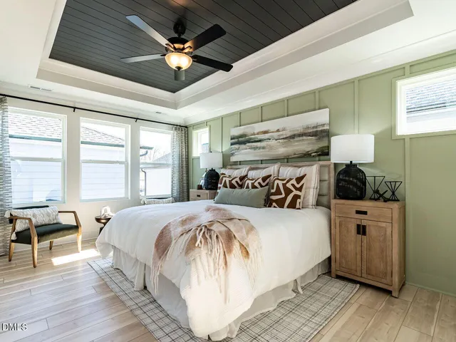 a bed room with a bed and a ceiling fan