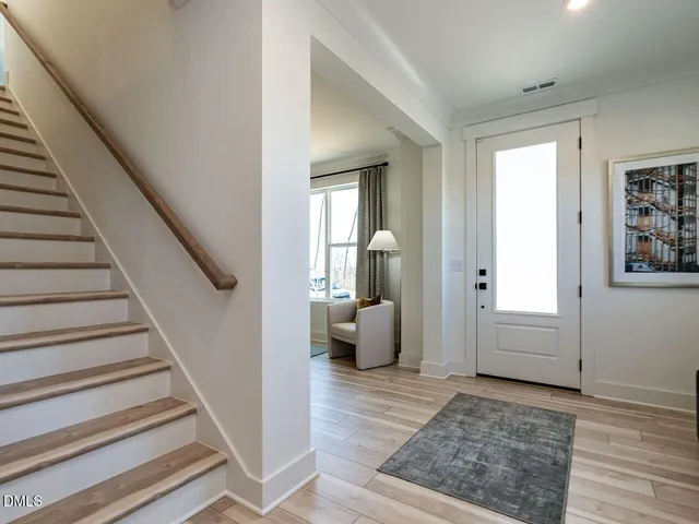 a view of a livingroom with wooden floor and furniture
