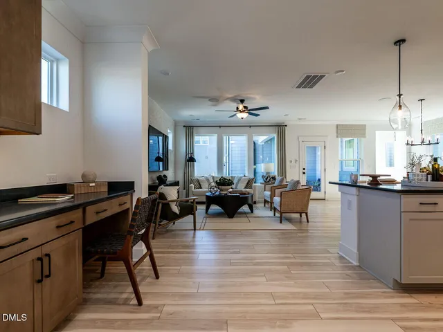 a very nice looking living room with kitchen and a wooden floor