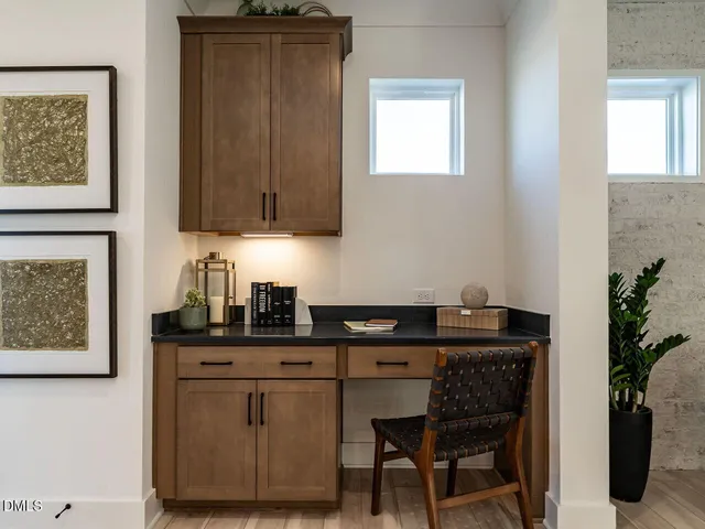 a kitchen with granite countertop a sink cabinets and wooden floor