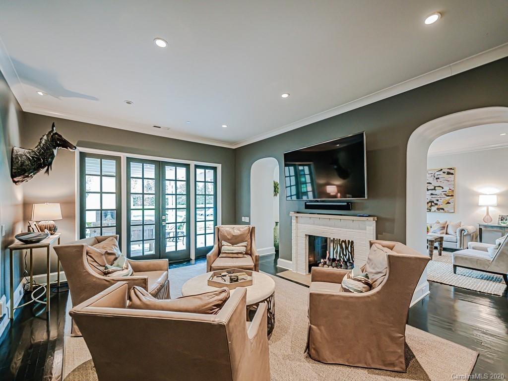 3429 Sharon Road Charlotte, NC 28211 - Photo 11 of 48 a living room with furniture a fireplace and a flat screen tv