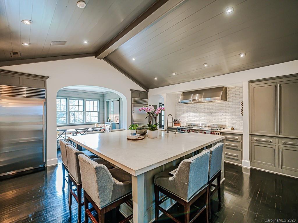 3429 Sharon Road Charlotte, NC 28211 - Photo 13 of 48 a kitchen with a table chairs and refrigerator