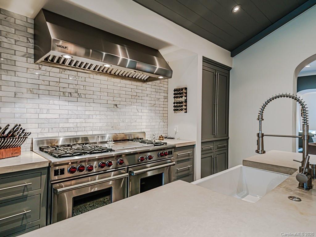 3429 Sharon Road Charlotte, NC 28211 - Photo 16 of 48 a kitchen with granite countertop a stove and a refrigerator