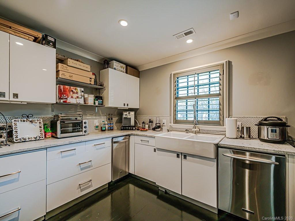 3429 Sharon Road Charlotte, NC 28211 - Photo 21 of 48 a kitchen that has a sink a stove and cabinets